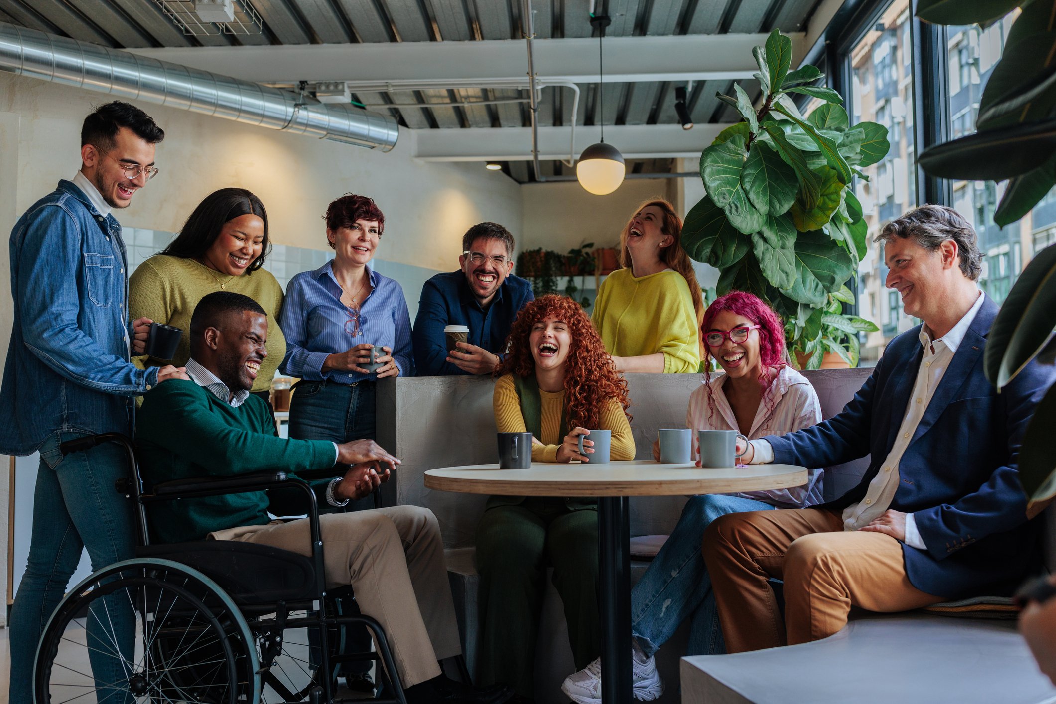 Diverse, happy group of colleagues around a table.